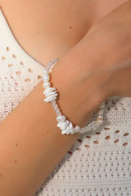 Freshwater pearls meet translucent beads and layered white details in a soft, airy composition.