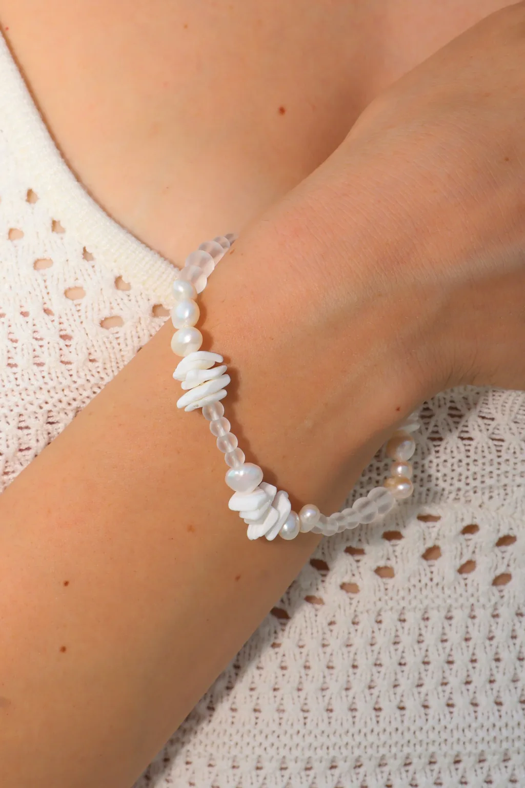 Freshwater pearls meet translucent beads and layered white details in a soft, airy composition.